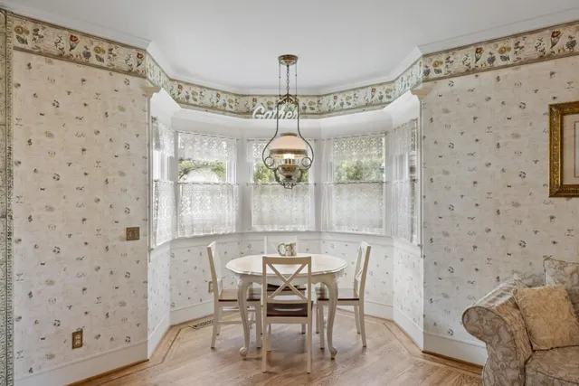 a dining room with furniture and window