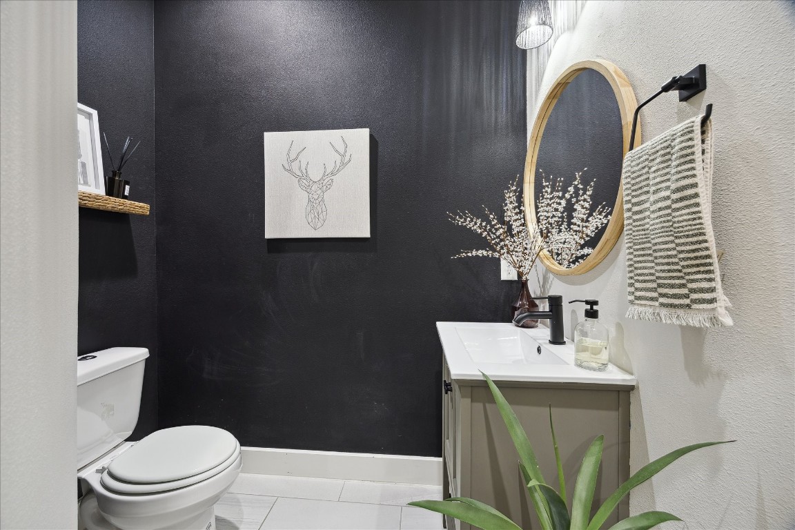 824 Morris Street Houston, TX 77009 - Photo 12 of 27 a bathroom with a toilet sink and mirror