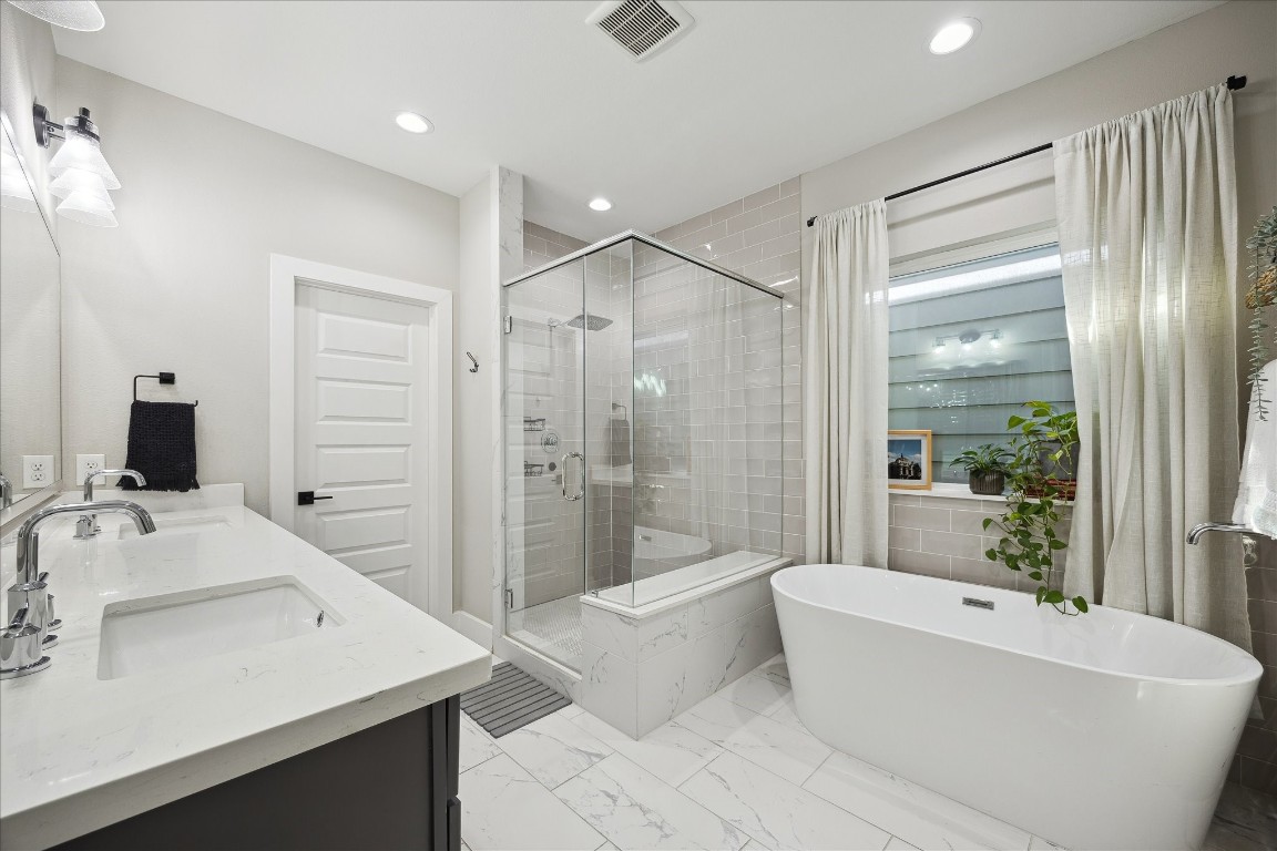 824 Morris Street Houston, TX 77009 - Photo 16 of 27 a bathroom with a tub a sink and a large mirror