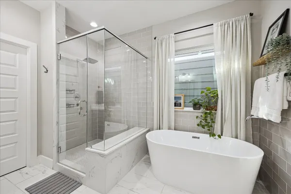 a bathroom with a bathtub and a shower