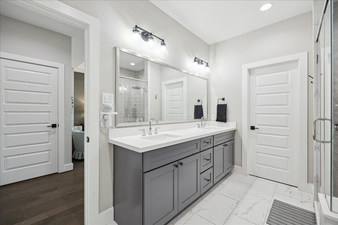 824 Morris Street Houston, TX 77009 - Photo 18 of 27 a bathroom with a granite countertop sink a mirror and a shower