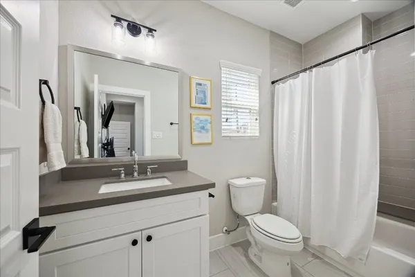 a bathroom with a toilet a sink and a mirror