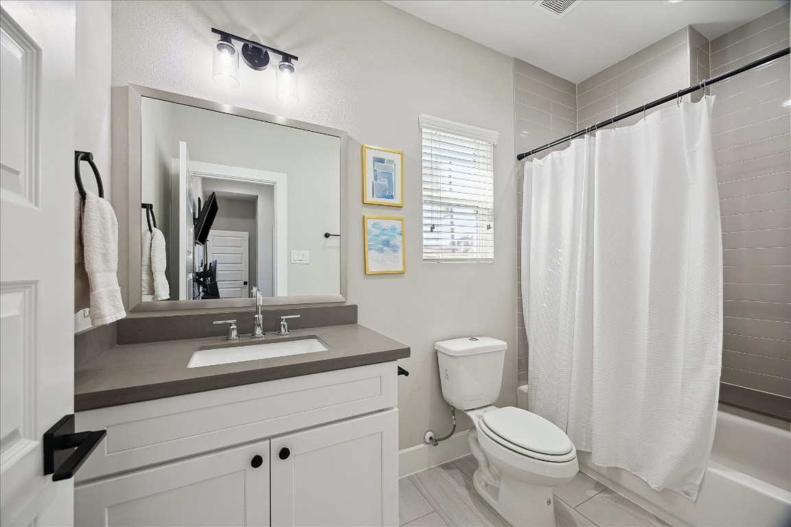824 Morris Street Houston, TX 77009 - Photo 20 of 27 a bathroom with a toilet a sink and a mirror