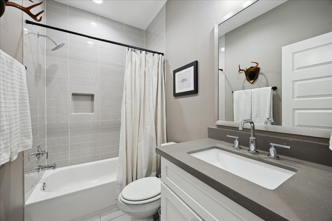 824 Morris Street Houston, TX 77009 - Photo 22 of 27 a bathroom with a granite countertop sink toilet and shower