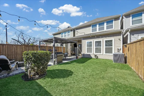 a view of a house with backyard sitting area and garden