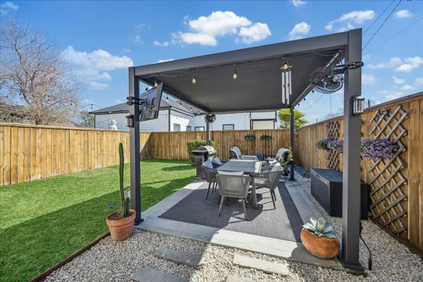 a view of a patio with table and chairs potted plants with wooden floor
