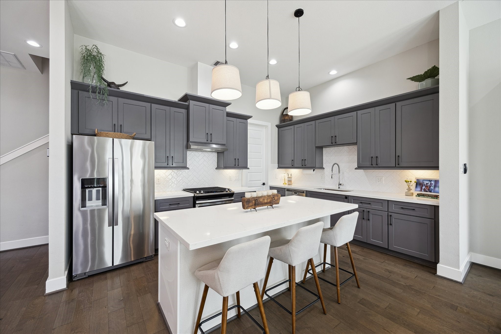 824 Morris Street Houston, TX 77009 - Photo 9 of 27 a kitchen with kitchen island a wooden floor and white appliances