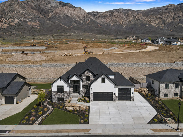 692 East Mountain Road North Ogden, UT 84414 - Photo 33 of 35 Modern two-story residence with a black shingle roof, white and gray stone facade, and black framed windows