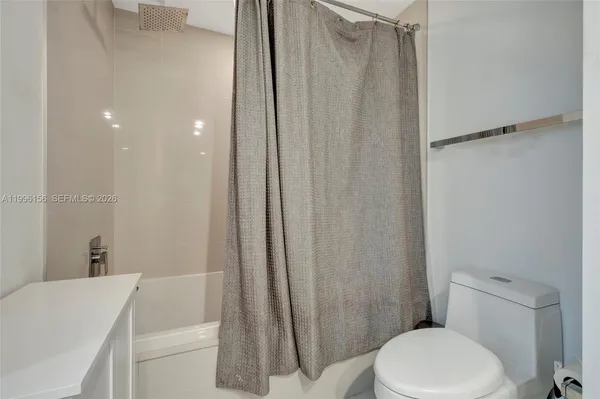 a view of a city from a balcony with a table and chair