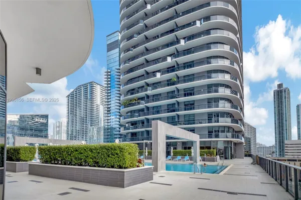 a view of a swimming pool with outdoor seating