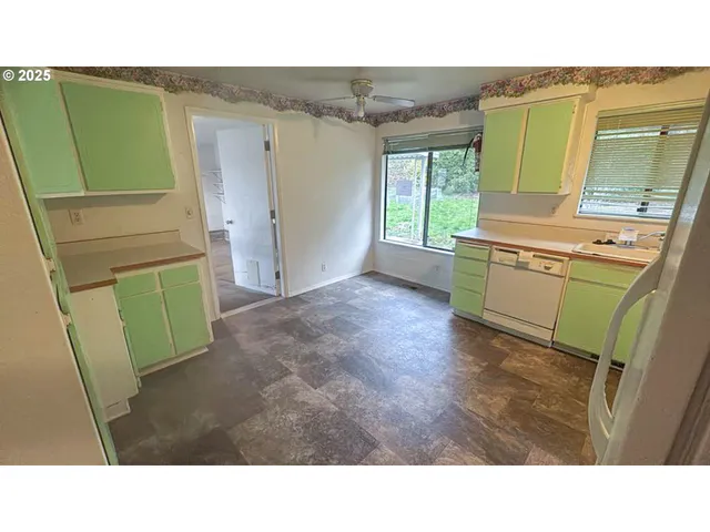 a room with washing machine and a window