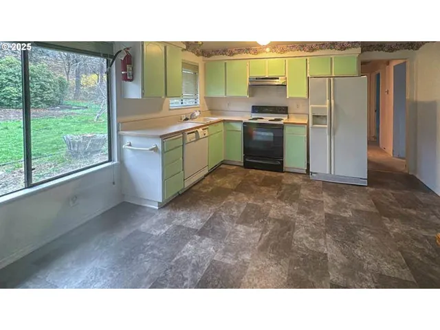 a kitchen with a sink stove and refrigerator