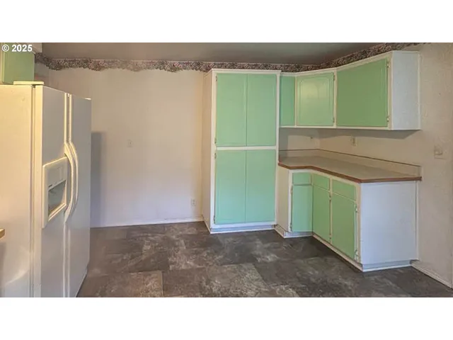 a kitchen with a refrigerator and a sink