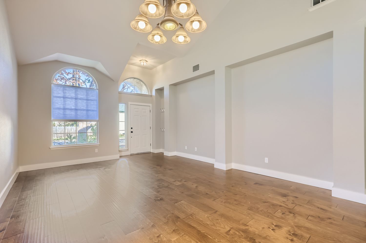 3805 Mankins Way Austin, TX 78728 - Photo 3 of 11 Foyer entrance featuring suspended lighting, dark wood-style flooring, and vaulted ceiling