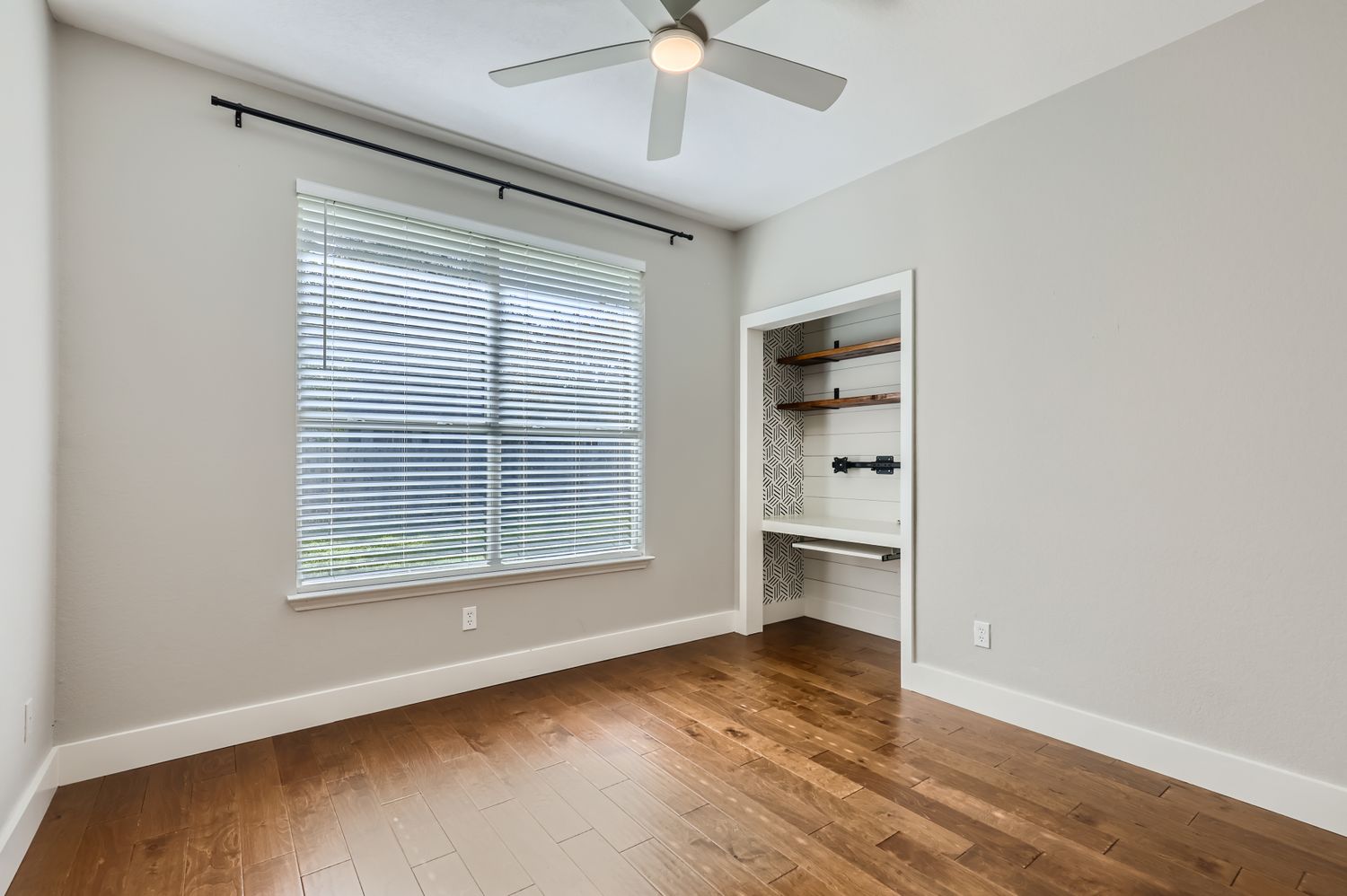 3805 Mankins Way Austin, TX 78728 - Photo 6 of 11 Unfurnished bedroom featuring dark wood-style floors, a ceiling fan, and a closet