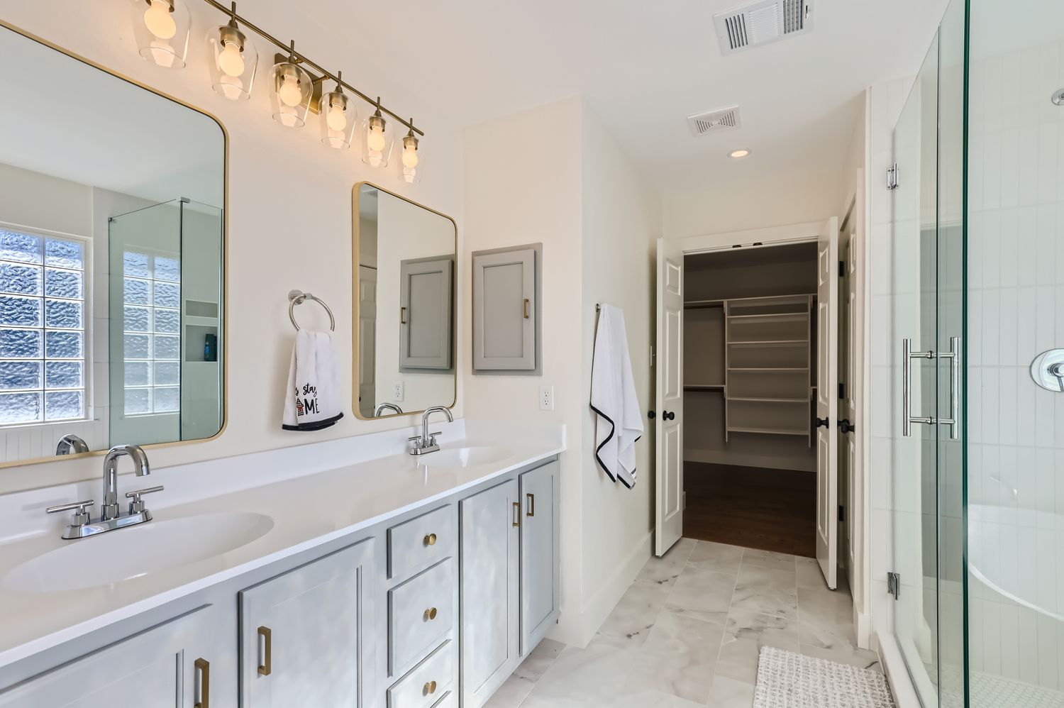 3805 Mankins Way Austin, TX 78728 - Photo 7 of 11 Full bath featuring double vanity, a spacious closet, a shower stall, and recessed lighting