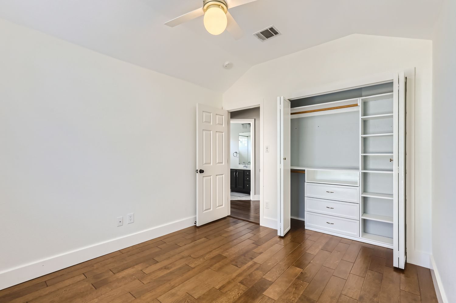 3805 Mankins Way Austin, TX 78728 - Photo 8 of 11 Unfurnished bedroom featuring lofted ceiling, a closet, dark wood-style flooring, and ceiling fan