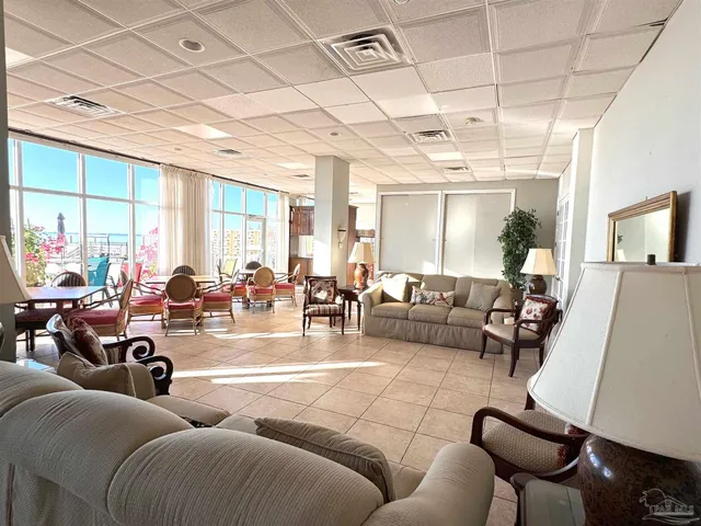 a living room with furniture and a wall painting