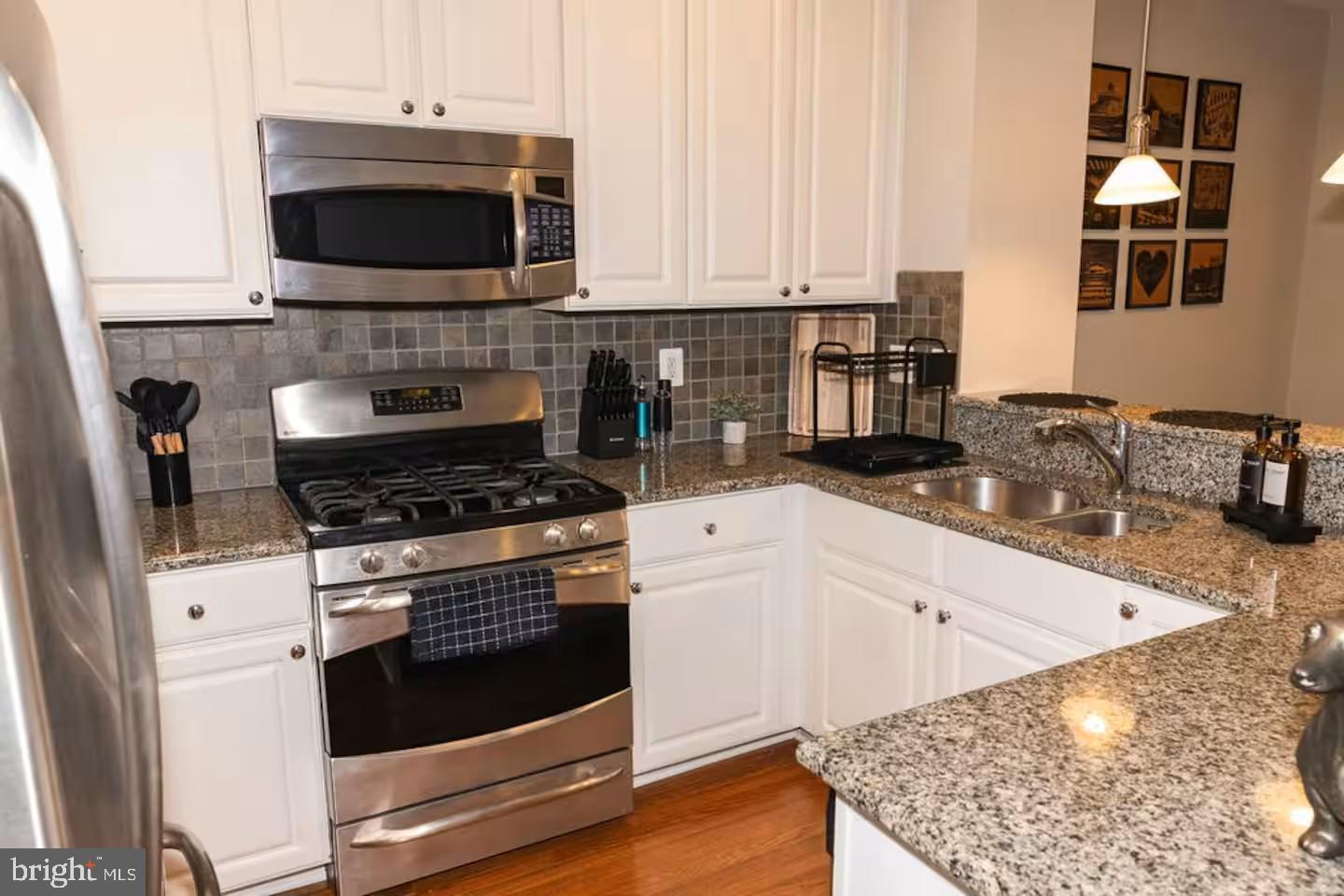 24 South Regester Street Baltimore, MD 21231 - Photo 3 of 32 Sleek kitchen with stainless steel appliances