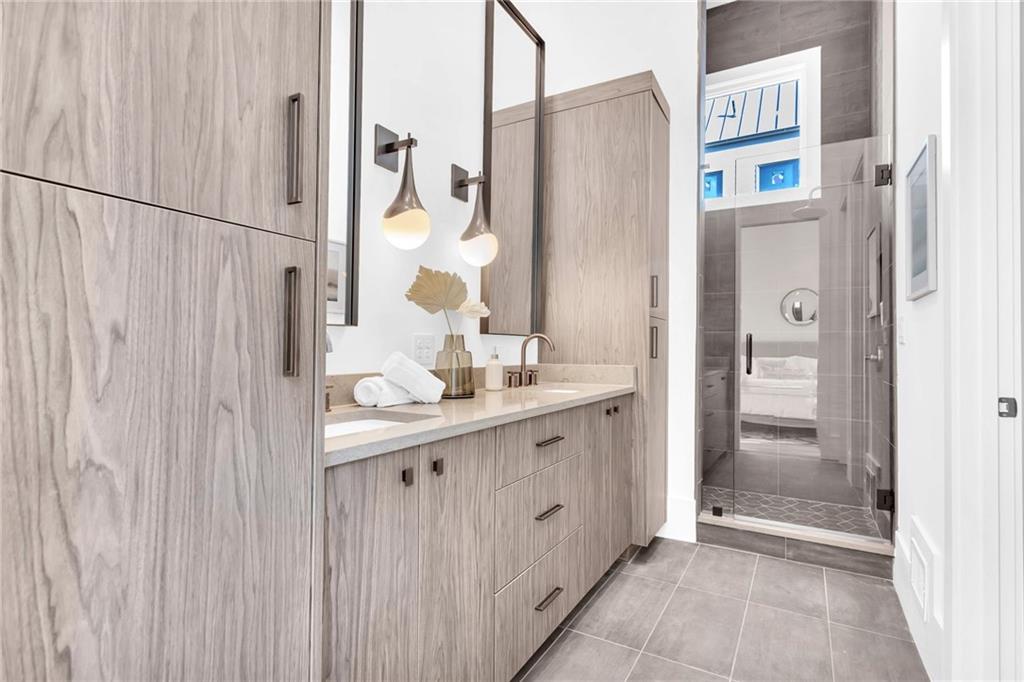 1250 Lupo Loop Chattahoochee Hills, GA 30268 - Photo 25 of 49 a bathroom with a double vanity sink and a mirror