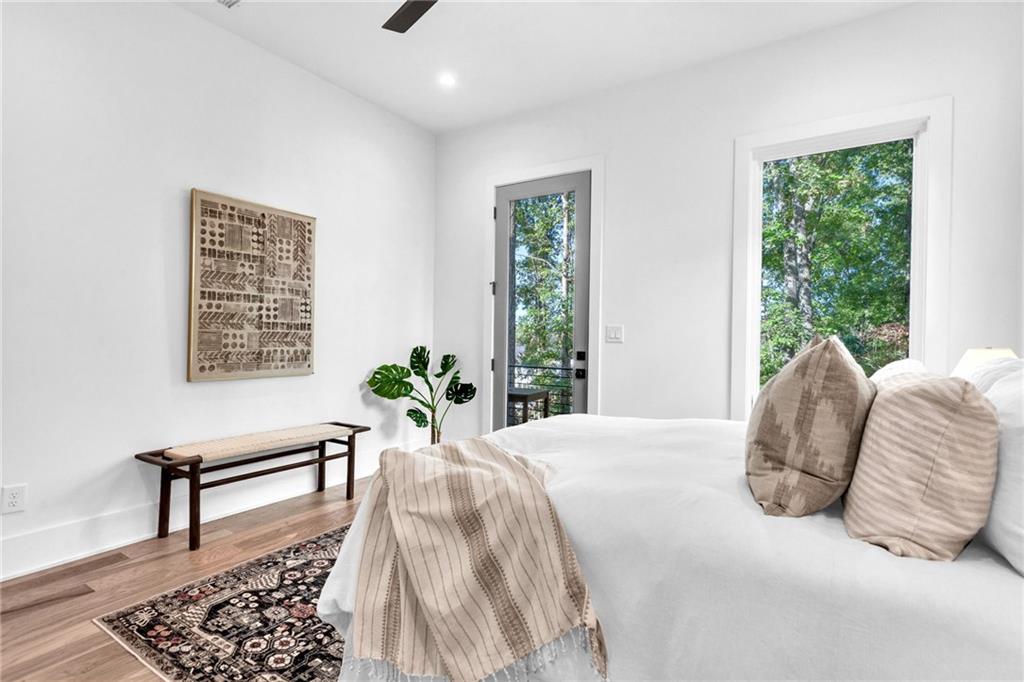 1250 Lupo Loop Chattahoochee Hills, GA 30268 - Photo 33 of 49 a bed sitting in a bedroom next to a window