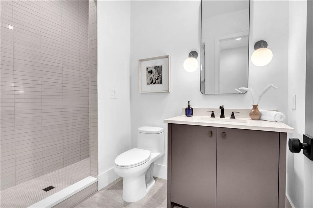 1250 Lupo Loop Chattahoochee Hills, GA 30268 - Photo 35 of 49 a bathroom with a toilet sink and mirror