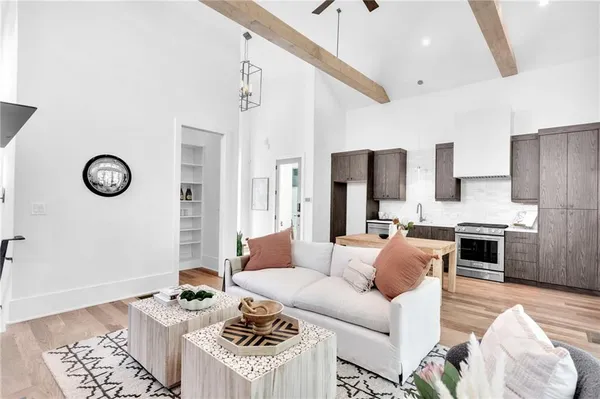 a living room with a large window a table and chairs