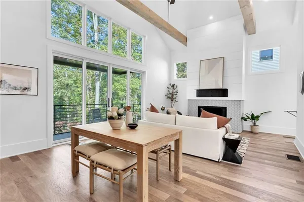 a living room with furniture a fireplace and wooden floor
