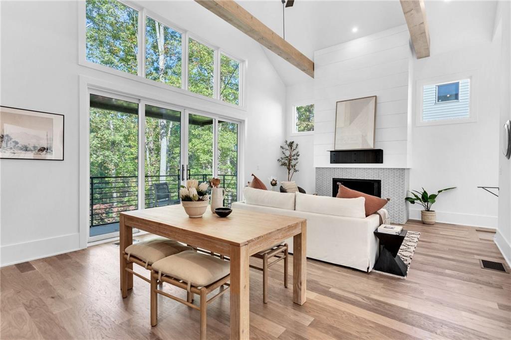 1250 Lupo Loop Chattahoochee Hills, GA 30268 - Photo 7 of 49 a living room with a large window a table and chairs