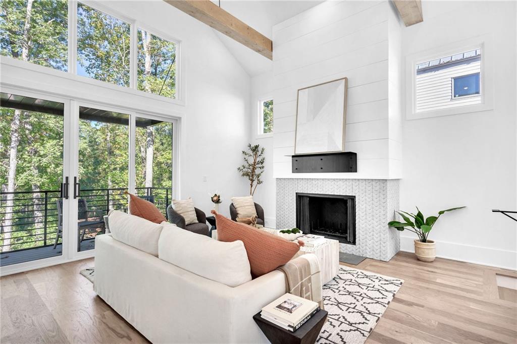 1250 Lupo Loop Chattahoochee Hills, GA 30268 - Photo 8 of 49 a living room with furniture a fireplace and wooden floor
