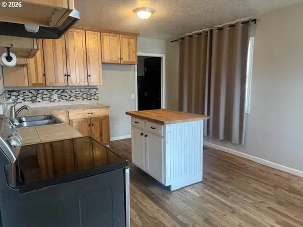a kitchen with a wooden floor and a sink