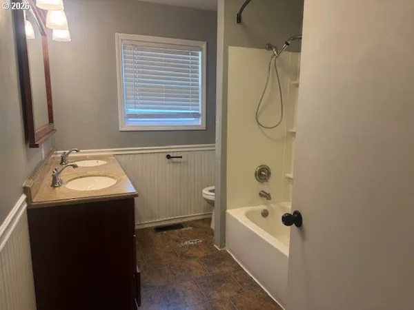 a view of a room with wooden floor and a window