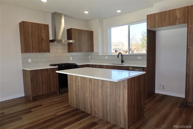 a kitchen with stainless steel appliances granite countertop a sink a microwave a refrigerator and wooden cabinets