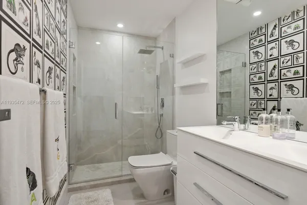 a bathroom with a sink toilet and shower