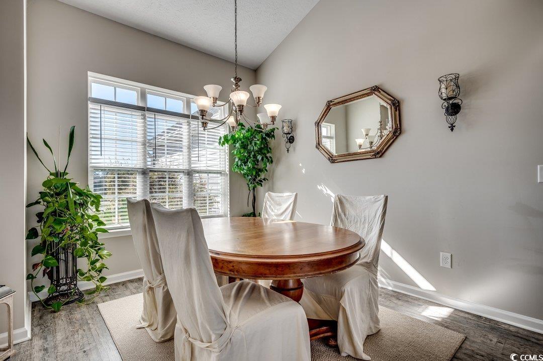 257 Leste Road Myrtle Beach, SC 29588 - Photo 8 of 35 Dining space featuring lofted ceiling, a chandelie