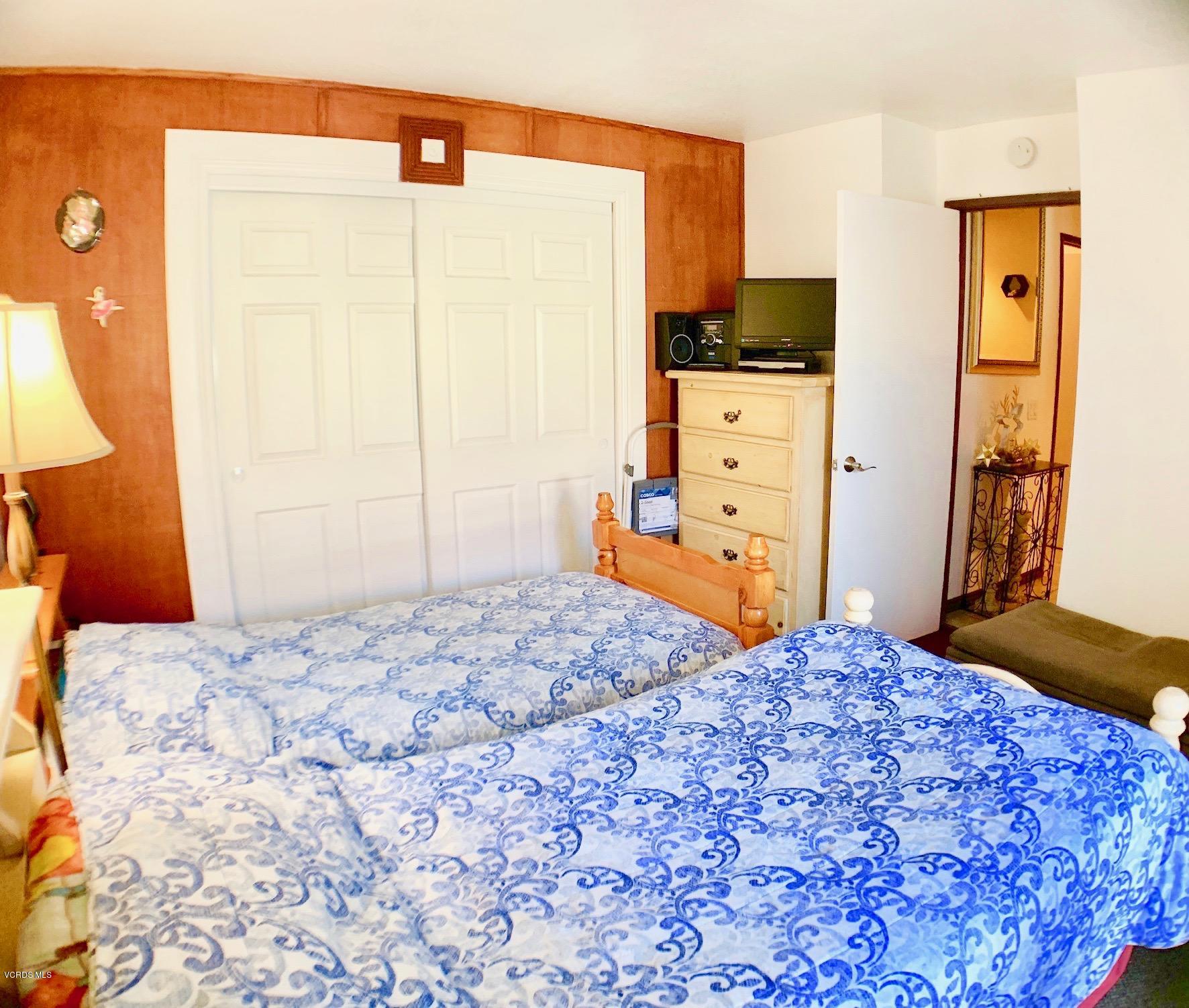4562 Saviers Road Oxnard, CA 93033 - Photo 19 of 29 a bedroom with a bed and wooden floor