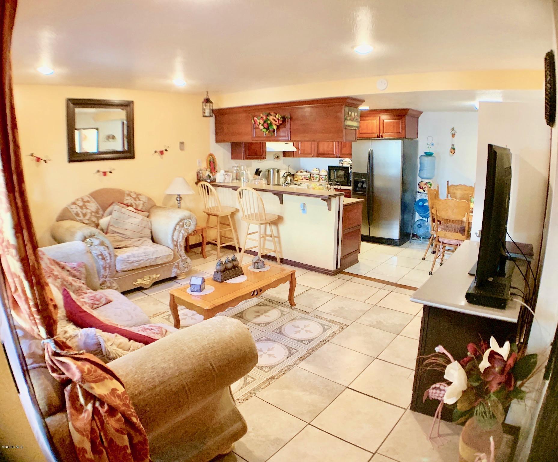 4562 Saviers Road Oxnard, CA 93033 - Photo 5 of 29 a living room with furniture a flat screen tv and a table