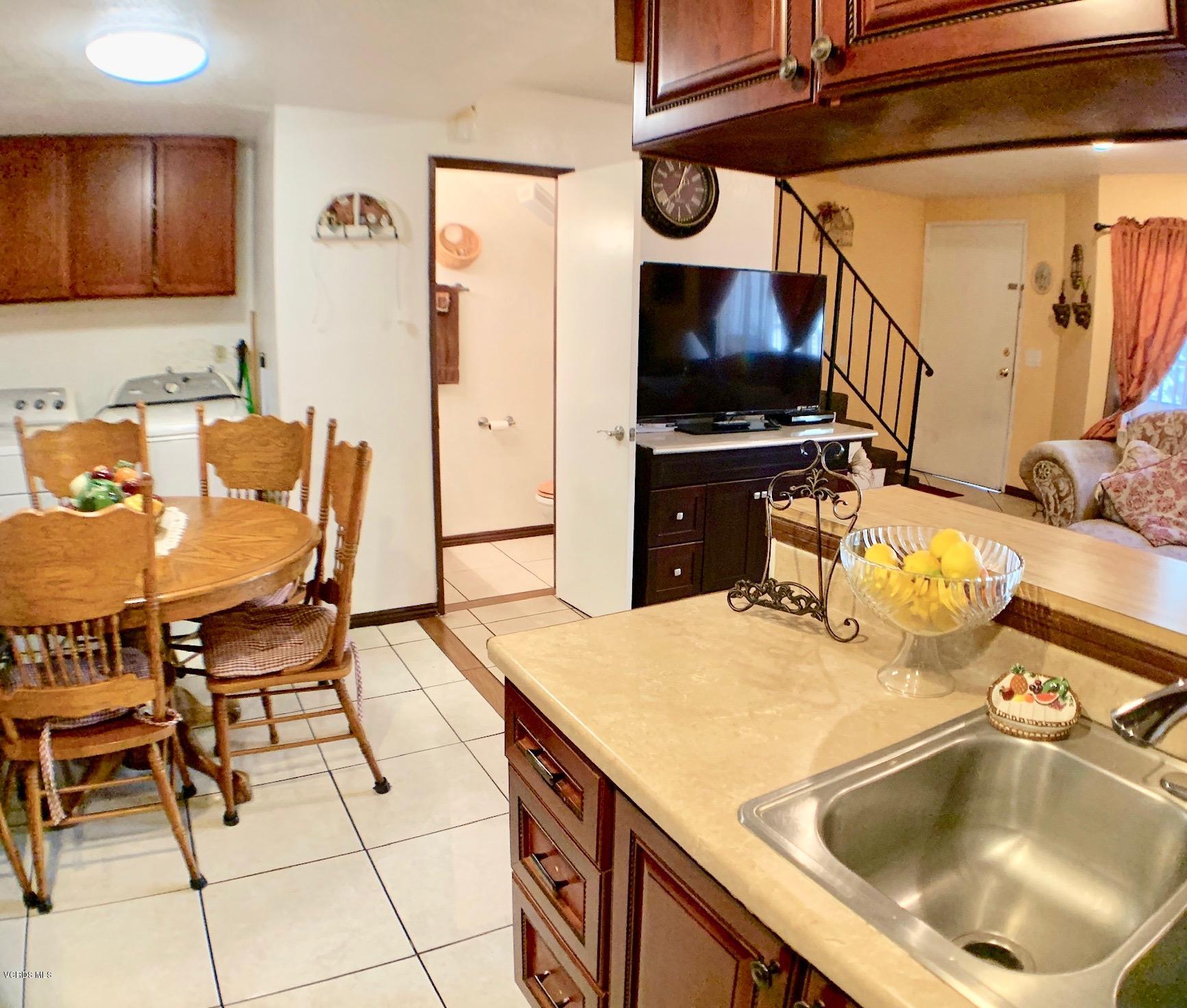 4562 Saviers Road Oxnard, CA 93033 - Photo 7 of 29 a kitchen with a sink a stove and a refrigerator