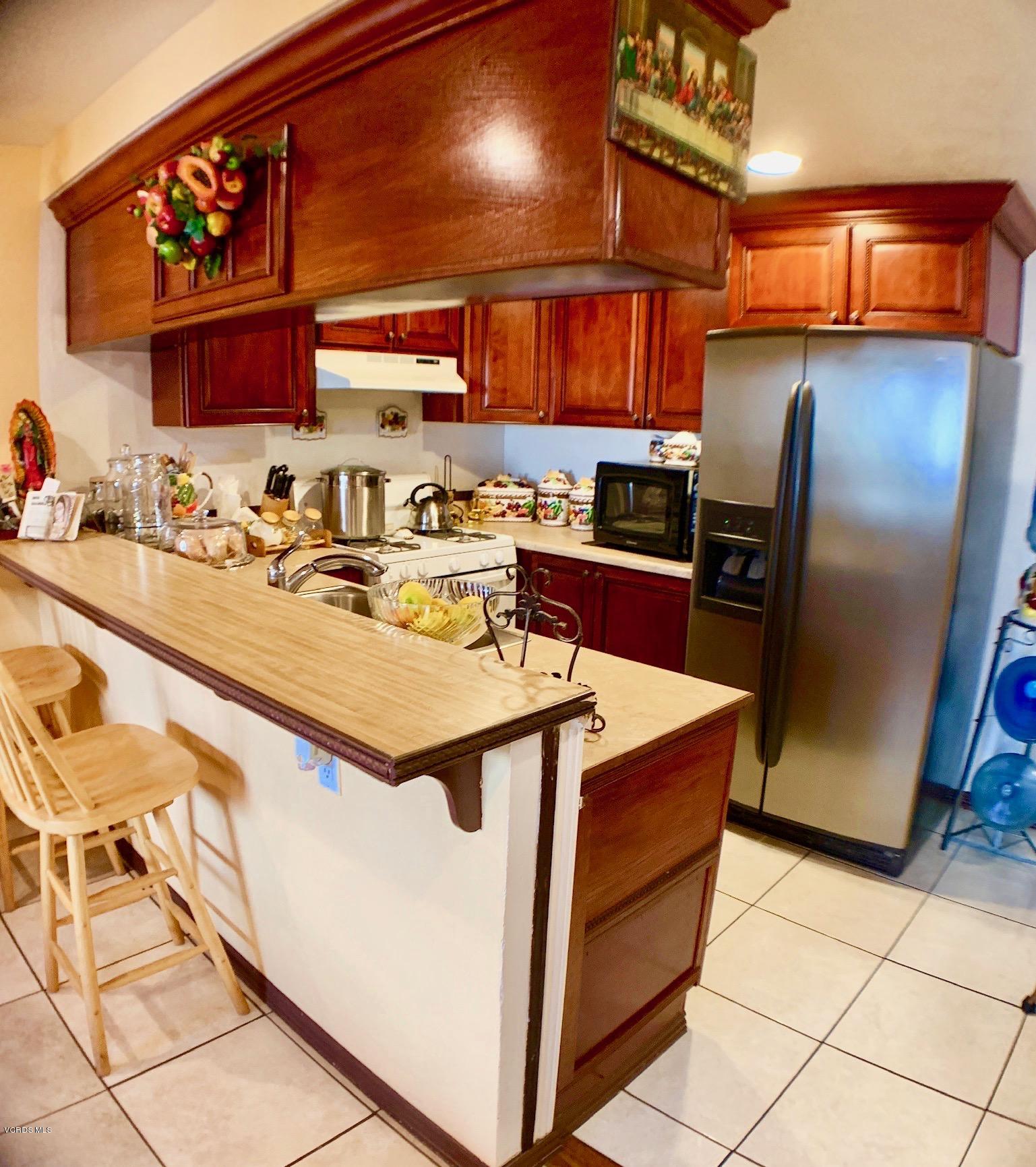 4562 Saviers Road Oxnard, CA 93033 - Photo 9 of 29 a kitchen with stainless steel appliances granite countertop a sink stove and refrigerator
