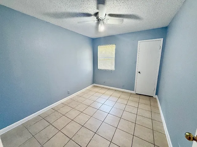 a view of an empty room and a window