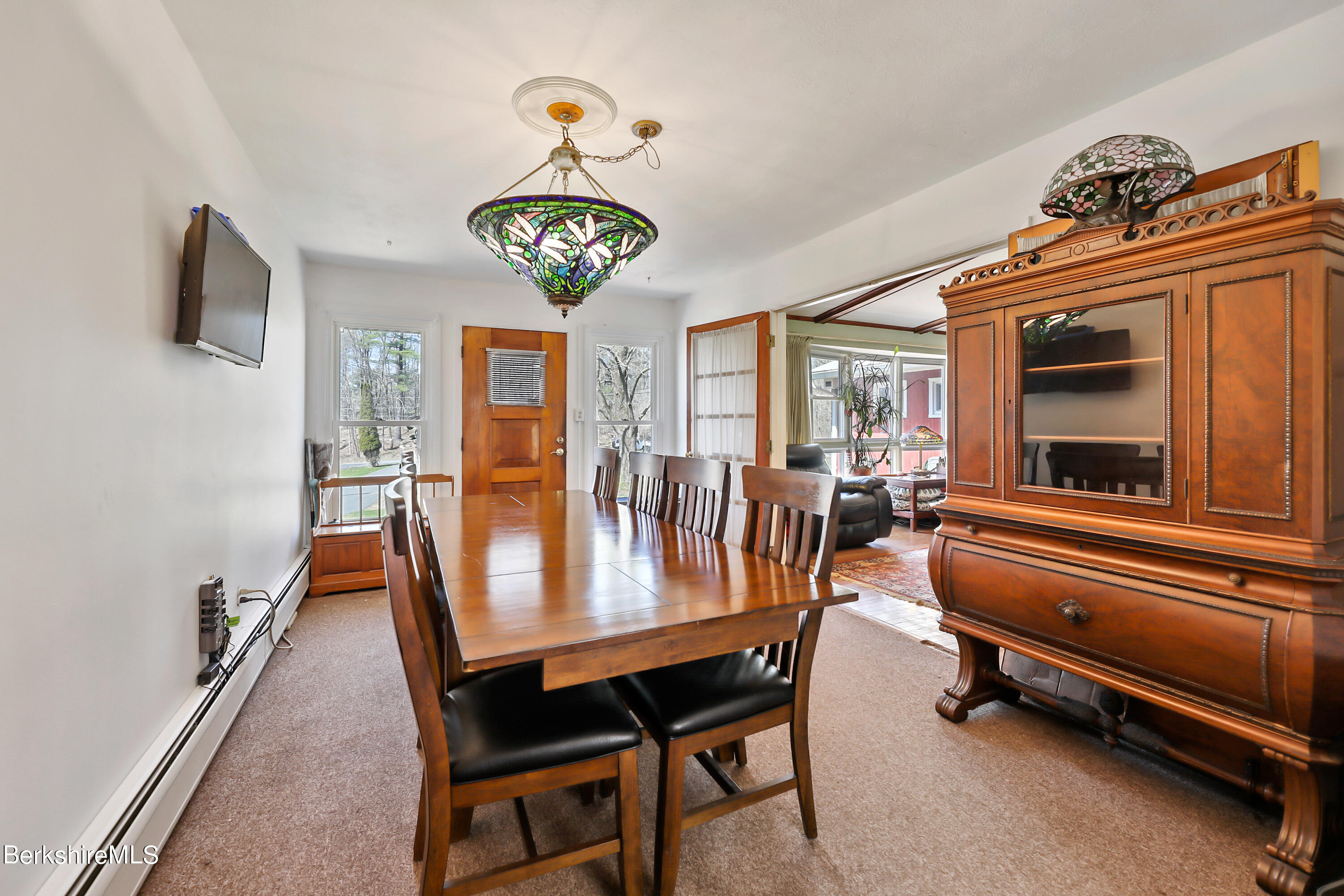 36 Lenox Road West Stockbridge, MA 01266 - Photo 11 of 30 a view of a dining room with furniture a chandelier and a flat screen tv