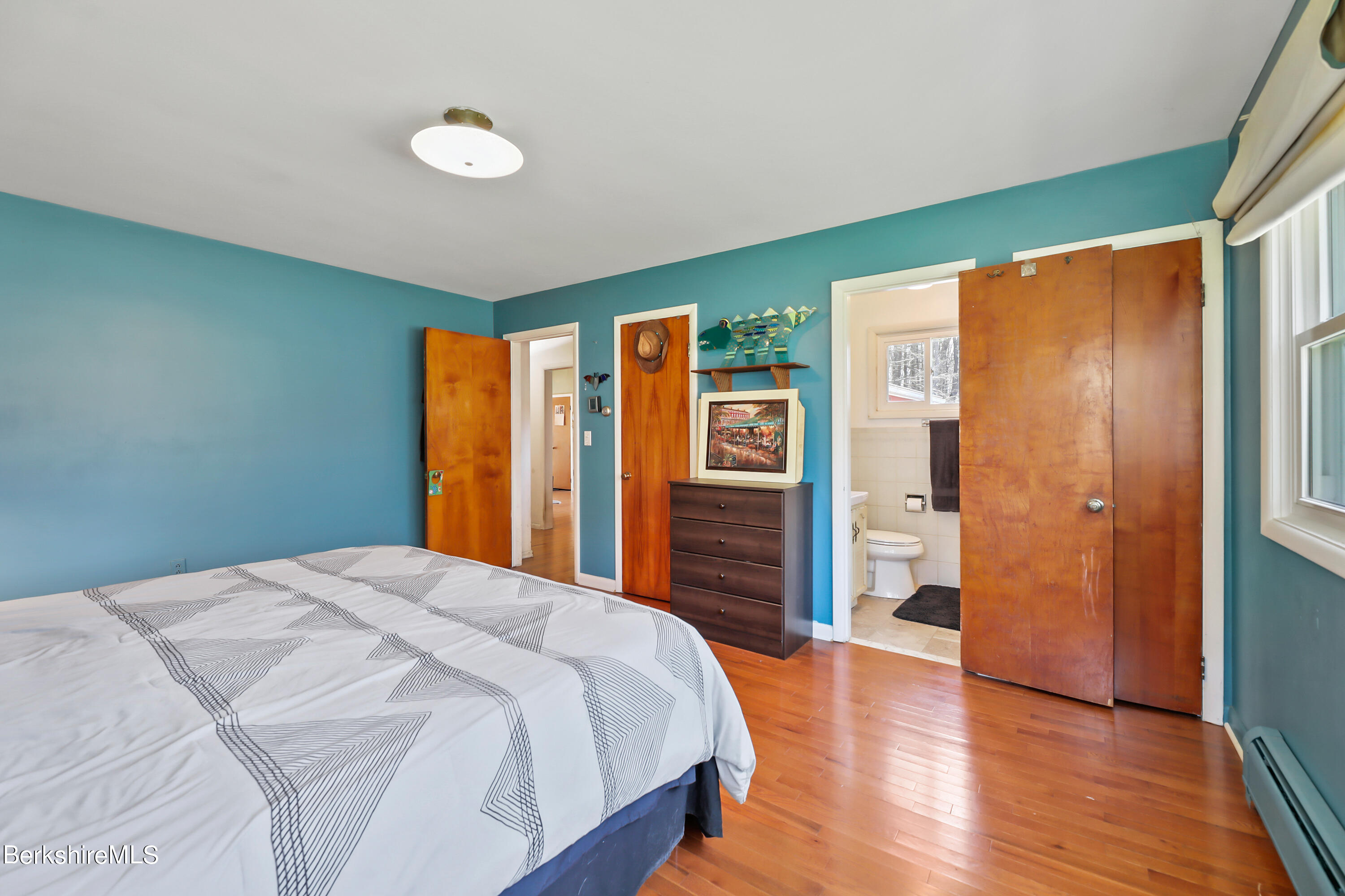 36 Lenox Road West Stockbridge, MA 01266 - Photo 17 of 30 a bedroom with a large bed and wooden floor