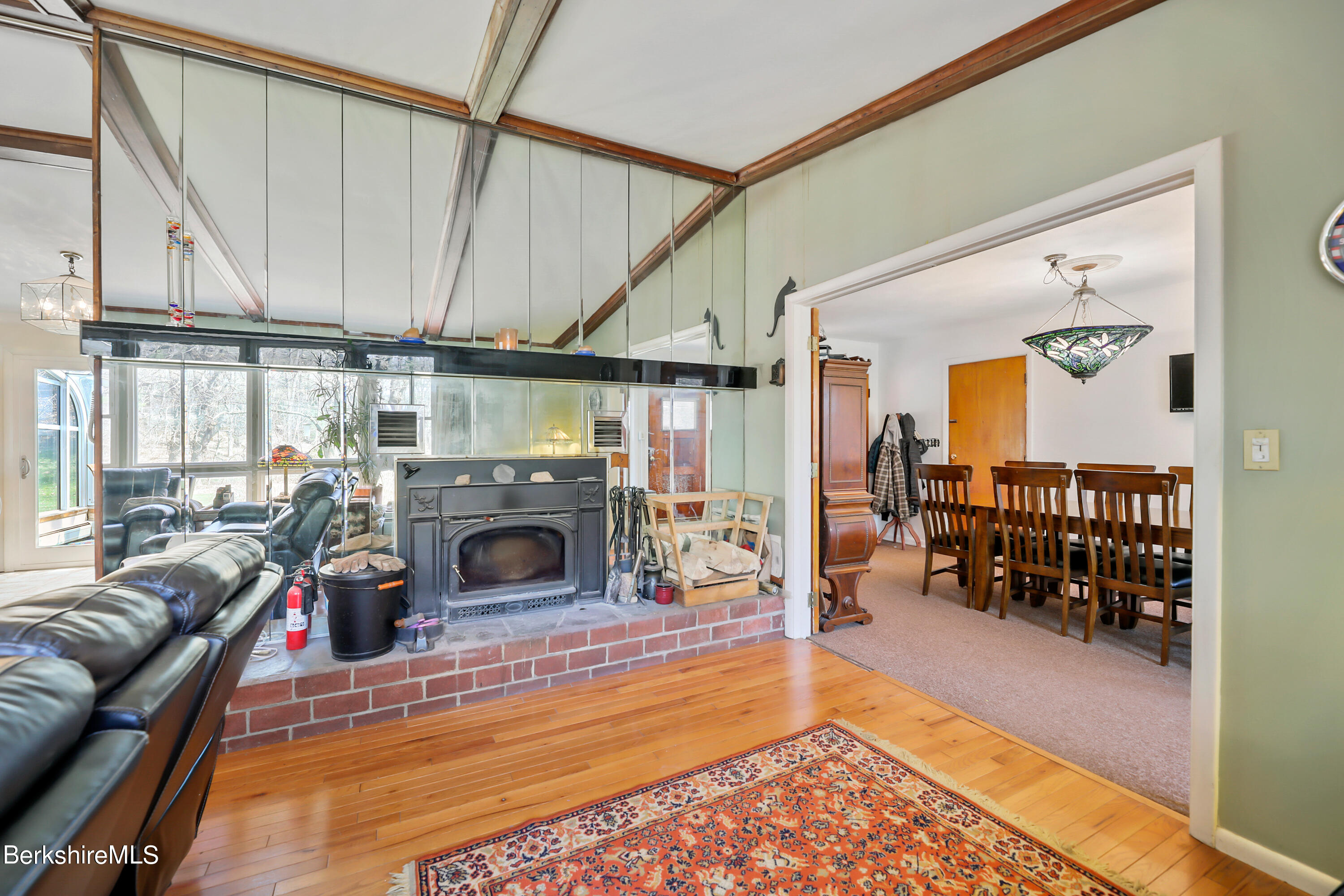36 Lenox Road West Stockbridge, MA 01266 - Photo 8 of 30 a living room with furniture a fireplace and a floor to ceiling window