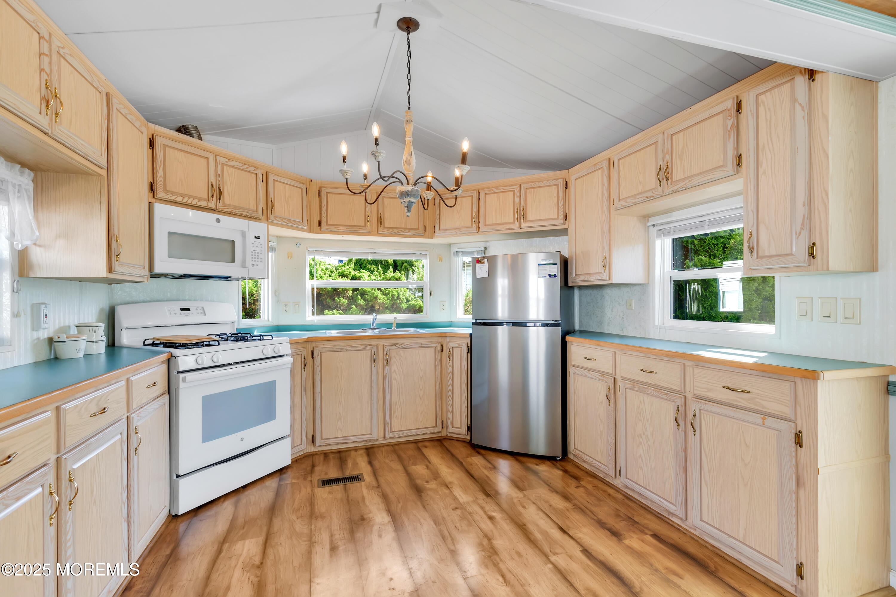 709 Union Avenue, Unit 3 Brielle, NJ 08730 - Photo 8 of 17 a kitchen with stainless steel appliances granite countertop a sink a stove a refrigerator cabinets and a window