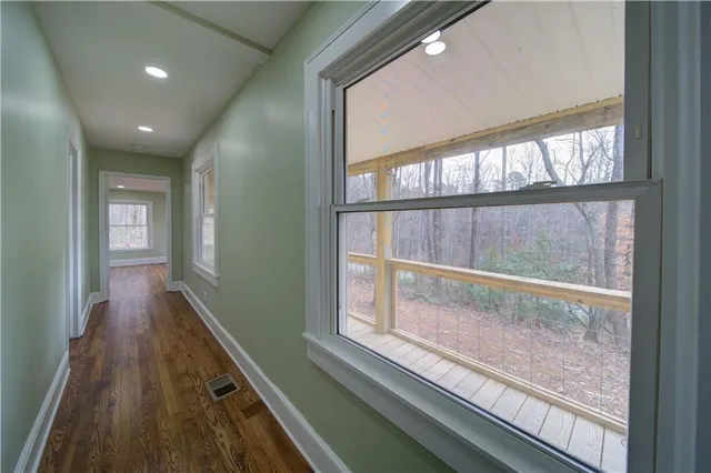 a view of hallway with wooden floor