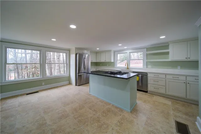 a kitchen with stainless steel appliances granite countertop a stove and a sink