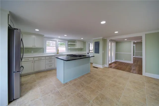 a large kitchen with a refrigerator and a sink