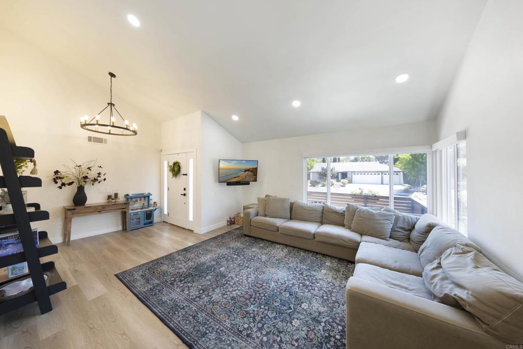 3577 Winslow Road Oceanside, CA 92056 - Photo 7 of 53 a living room with furniture and a chandelier