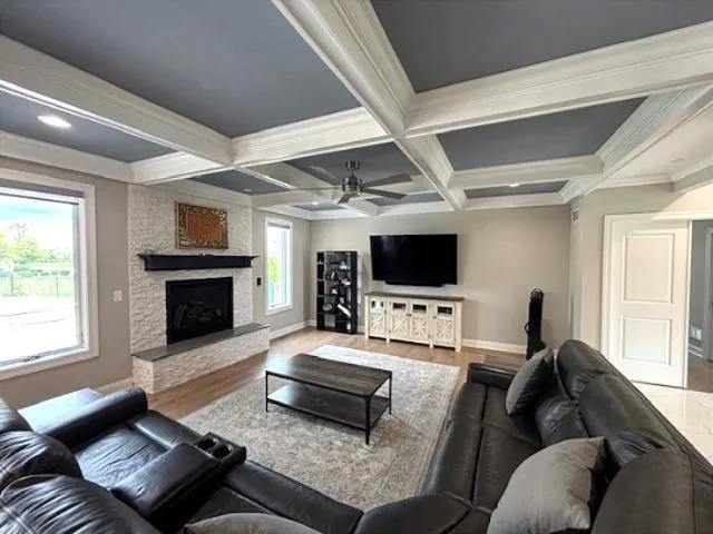 a living room with furniture a flat screen tv and a fireplace