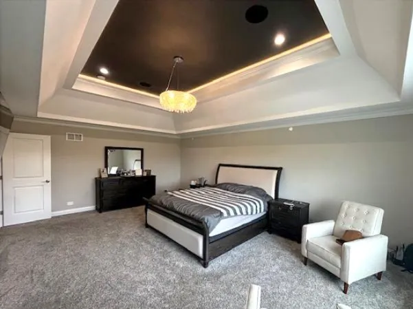 a spacious bedroom with a bed and a couch